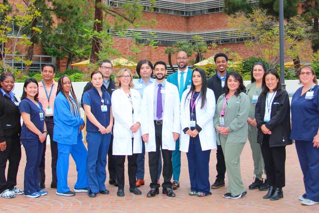 A group of diverse medical staff from the Office of Health Equity and Inclusive Excellence stand together