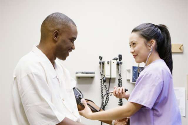 Nurse taking patient's blood pressure