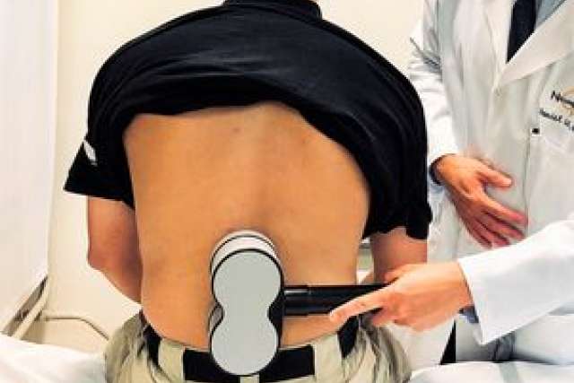 Stimulating the lower spinal cord with a magnetic device