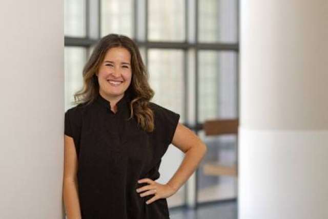 Rachel Frankenthal standing in a hallway, smiling