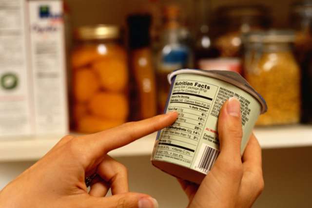 A person looks at a nutrition label
