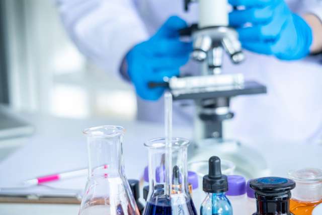 Cancer researcher working at a microscope