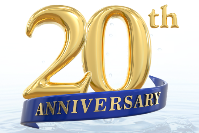 Gold 20th numerals with blue ribbon reading ANNIVERSARY above rippling water
