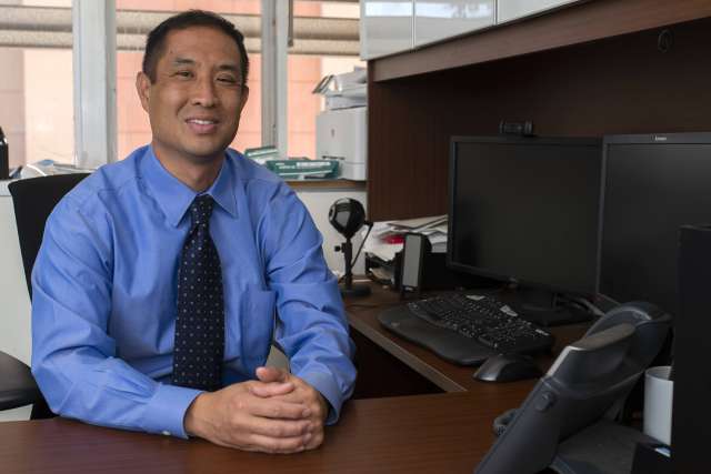 Dr. Timothy Fong sitting at desk