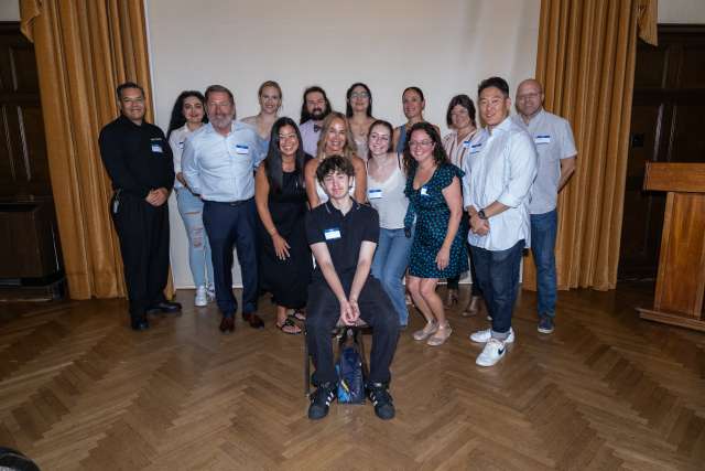 Luka Simunac poses for a photo with a group of his blood and platelet donors