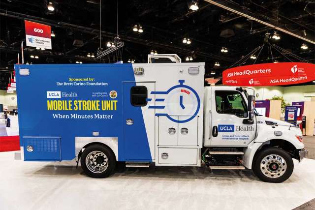 A mobile stroke unit ambulance is on display at a conference.