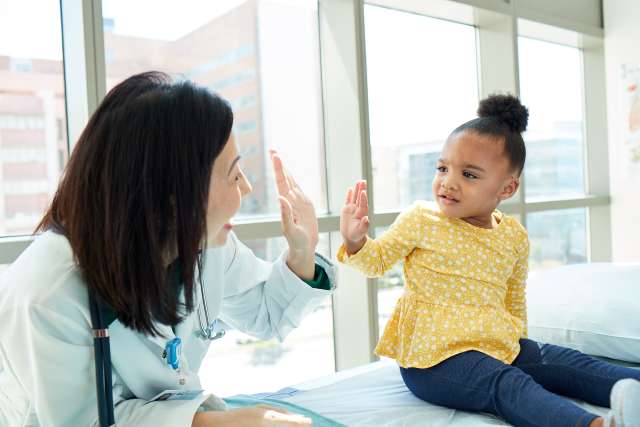 doctor high fiving child