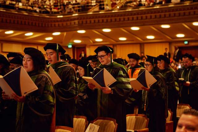 Graduating doctors read the Hippocratic oath in the Royce Hall auditorium at UCLA.