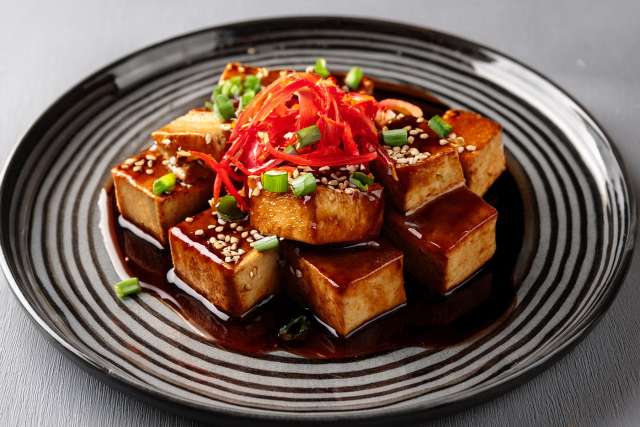 teryaki tofu on a black plate
