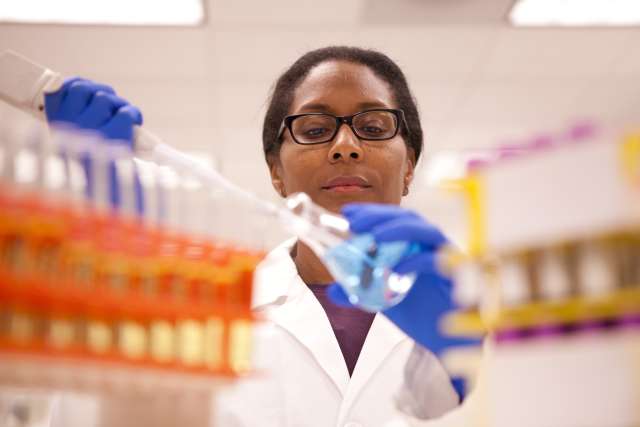 A doctor holding a beaker in lab.