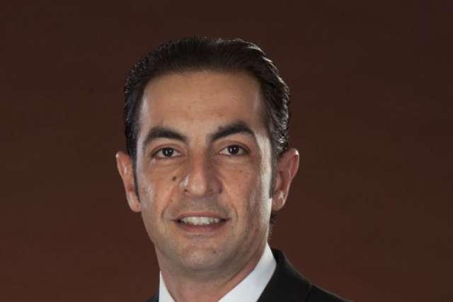 Person in dark suit and striped tie