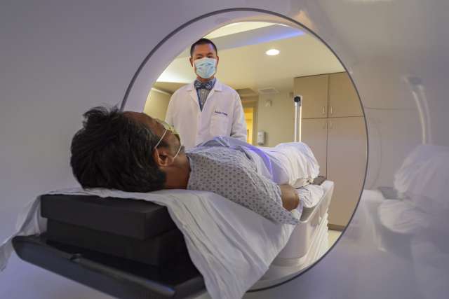 Doctor observing patient during radiation therapy