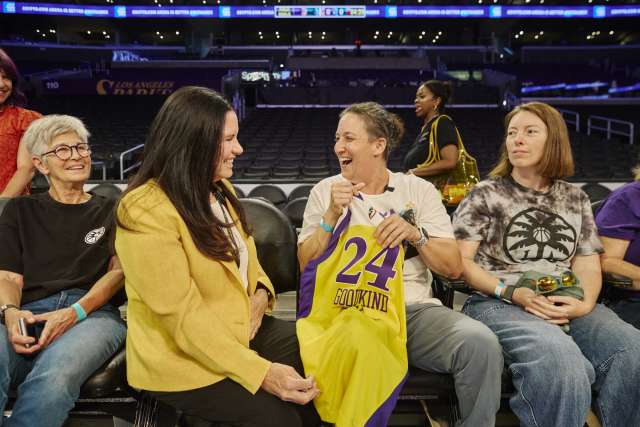 A patient sits courtside at an LA Sparks game with mother, doctor and finacee.