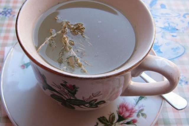 Floral teacup on saucer with steeping tea bag