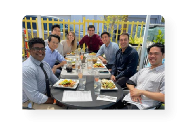 Eight members of the class of 2024 having lunch together.