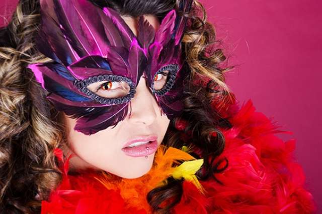 Woman wearing mask with feathers