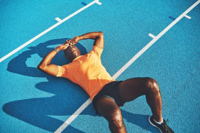 exhausted athlete on track after intense training