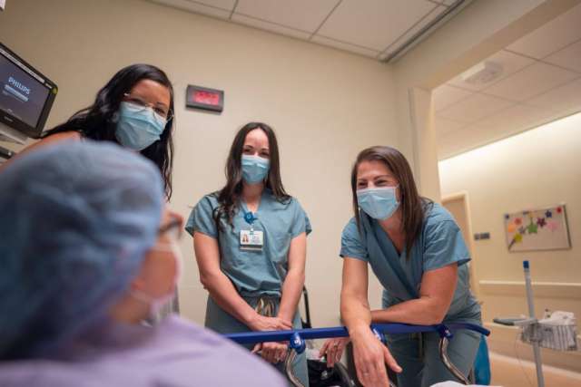 Dr. Rachel Thompson visits with her patient, Scarlett Ferguson.