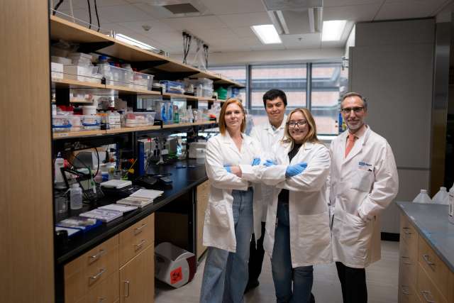 Dr. Antoni Ribas standing with members of his lab.