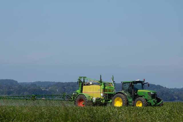 Farming vehicle in field