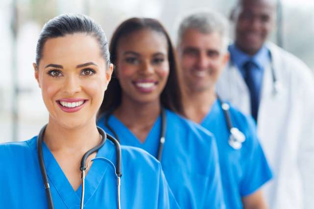 Smiling nurses and doctors in line
