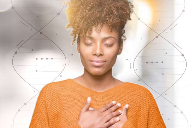 Woman with hands over heart and dna in background