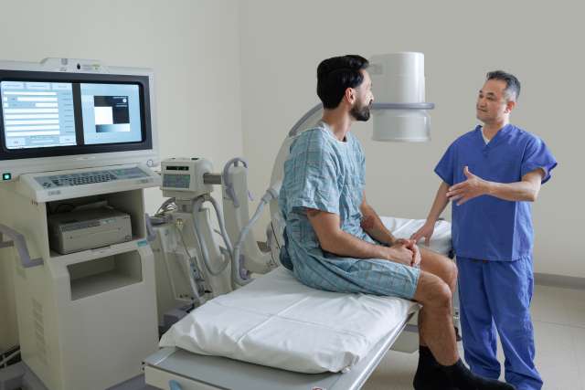 medical professional speaking to a patient in an exam room