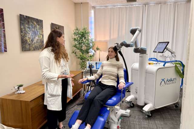 Doctor and patient receiving TMS treatment