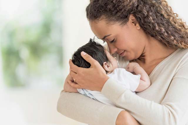 Mother cradling infant
