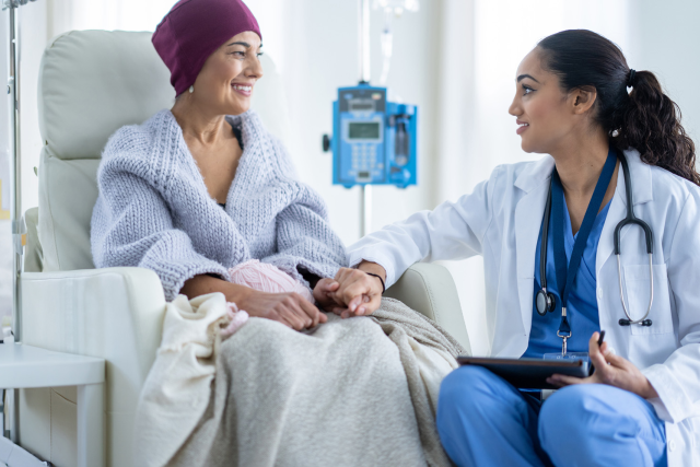 Doctor holding hand of cancer patient