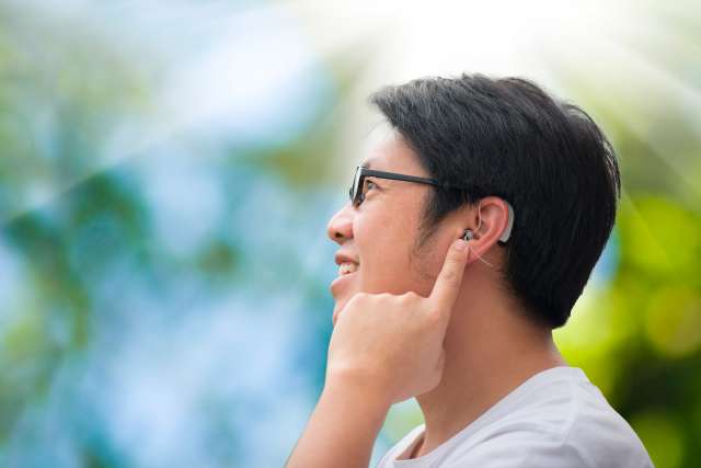Young man with hearing aids