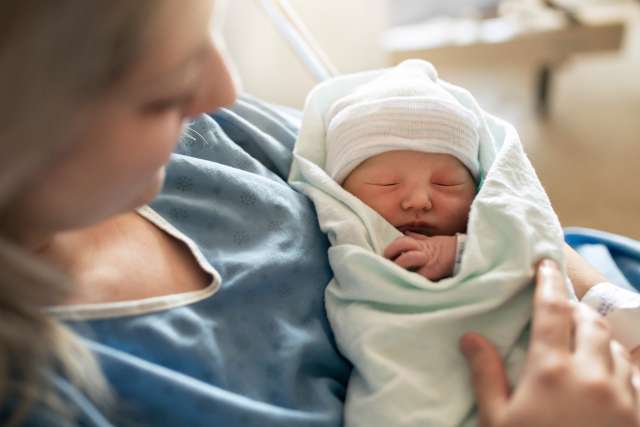 Mother with her newborn baby at the hospital a day after a natural birth labor