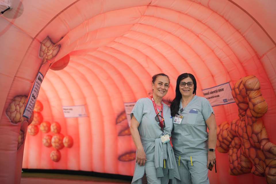 Two nurses inside inflatable colon during Colorectal Cancer Screening Campaign 2026