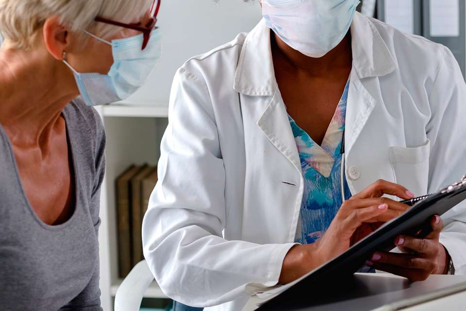 Female patient registration at front desk checking in