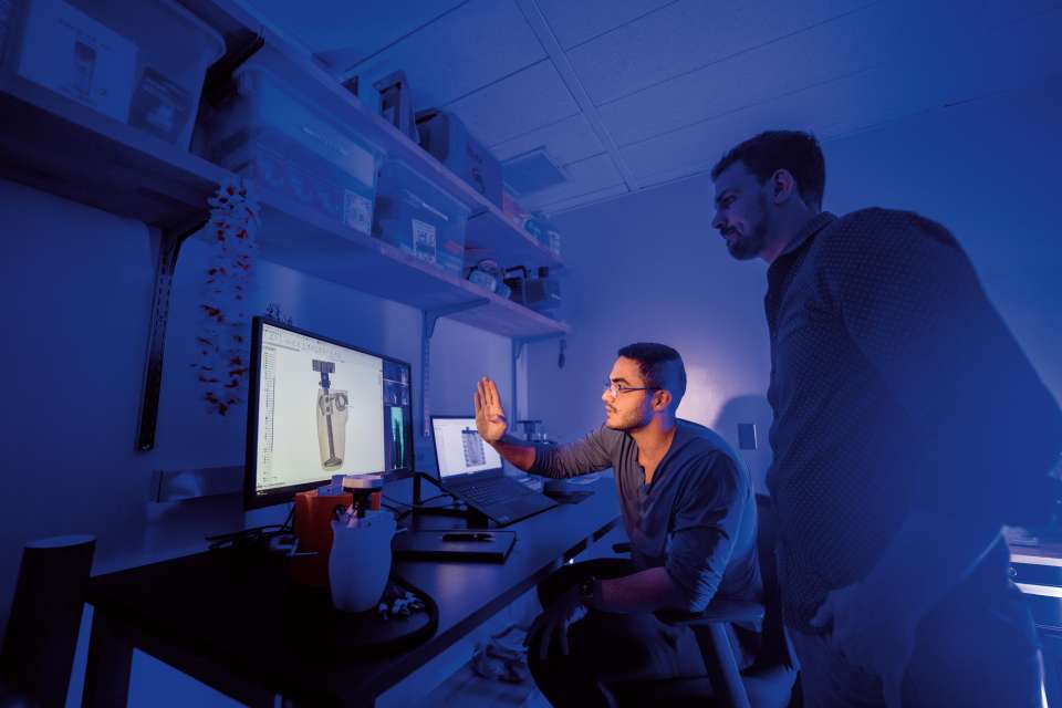 Amin Khatibi, a graduate student in mechanical engineering, works with Dr. Clites on the design of an advanced prosthetic device.