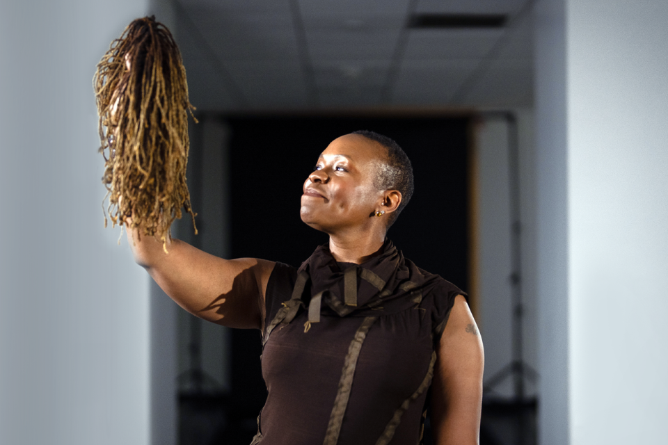 Melissa Watkins holds up the wig she made out of the hair she lost during chemotherapy. 