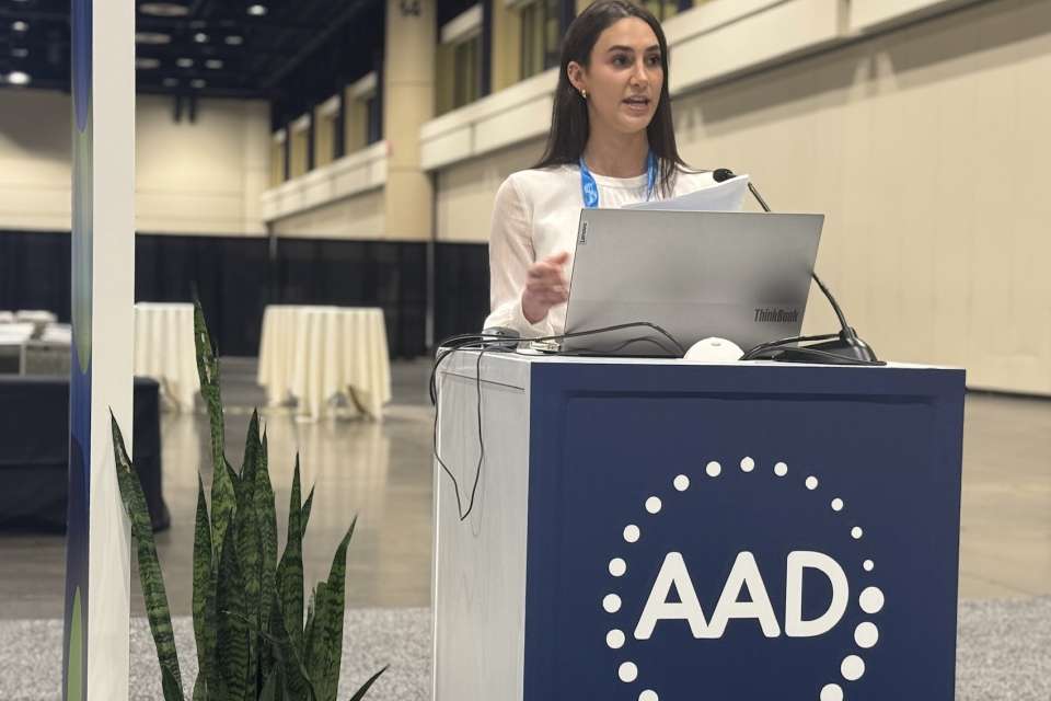 April Armstrong Lab fellow woman on a stand giving a presentation