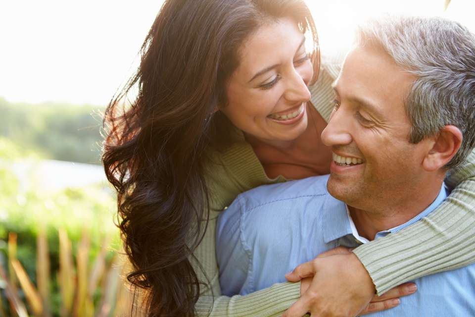 Couple hugging in a field