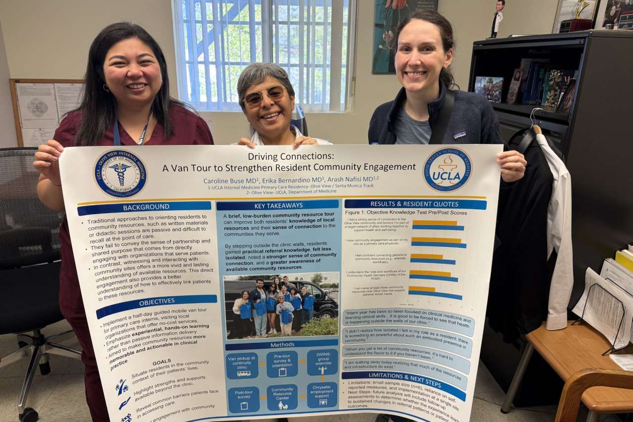 Primary care residents holding a poster
