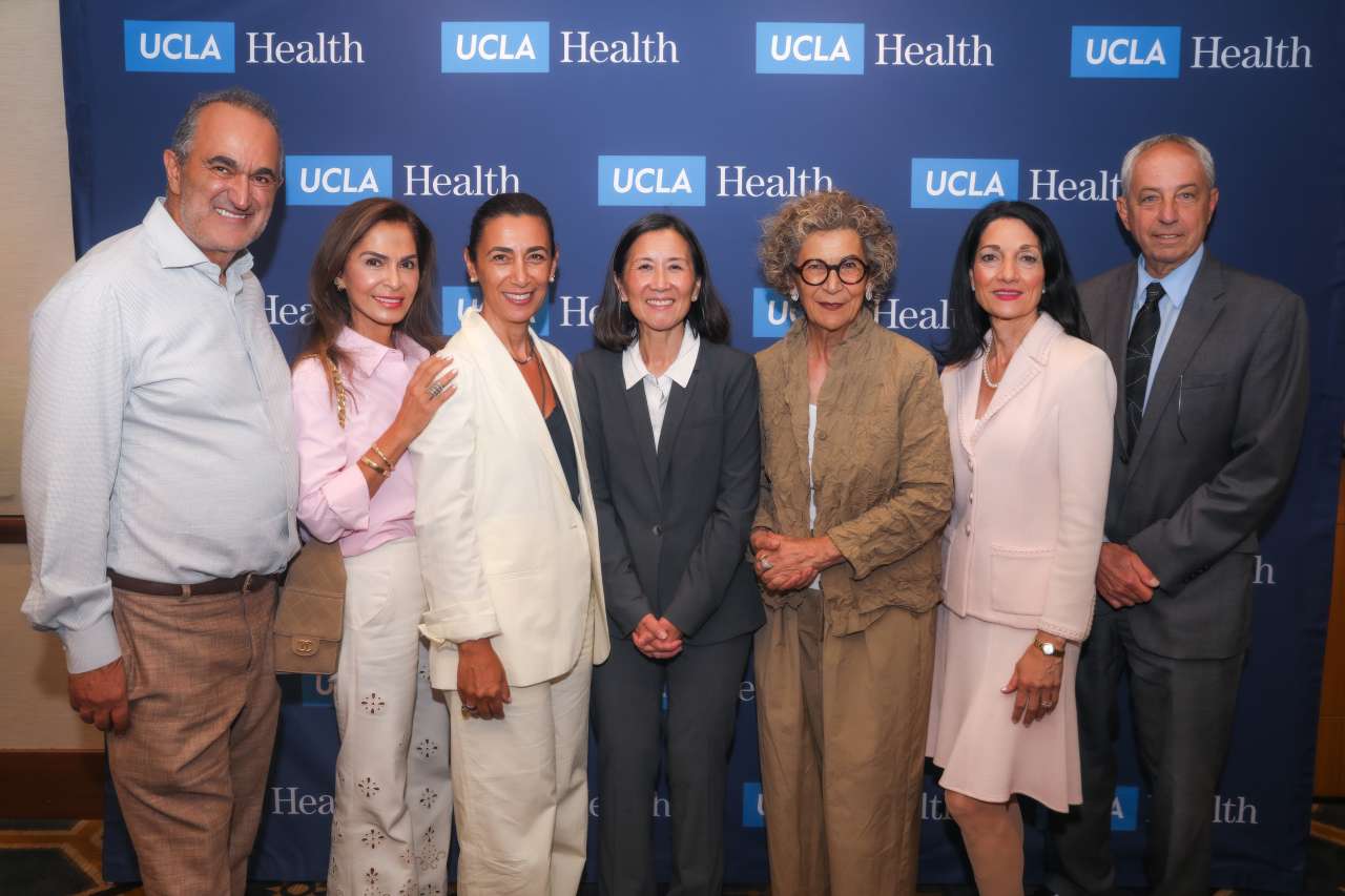 A group poses for a photo at an award ceremony.