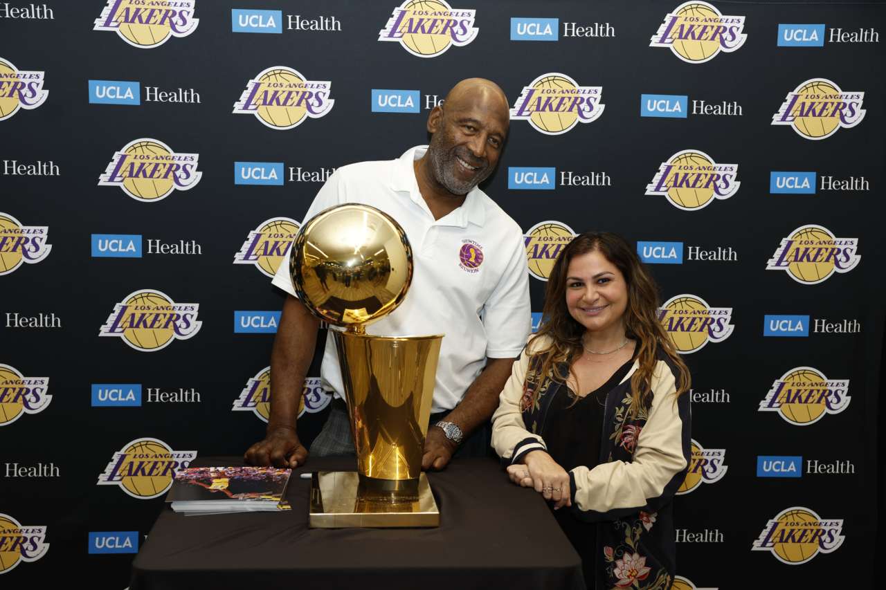 James Worthy with Christine Berberian Zenjiryan and the 1988 Lakers championship trophy