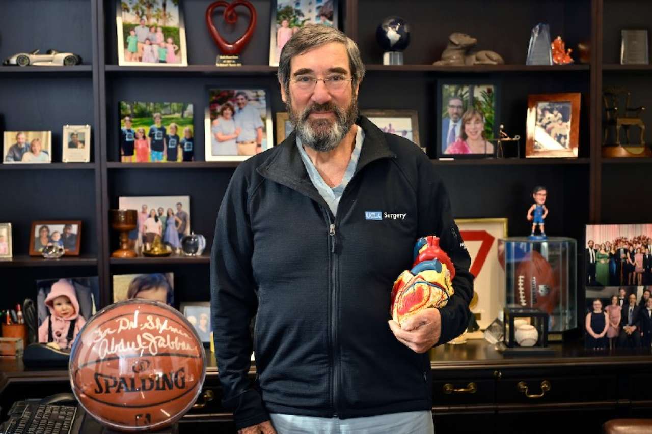 Dr. Shemin at desk with heart model and basketball