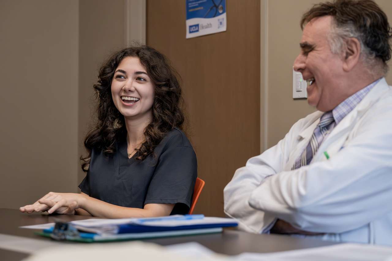 Medical intern and doctor laughing