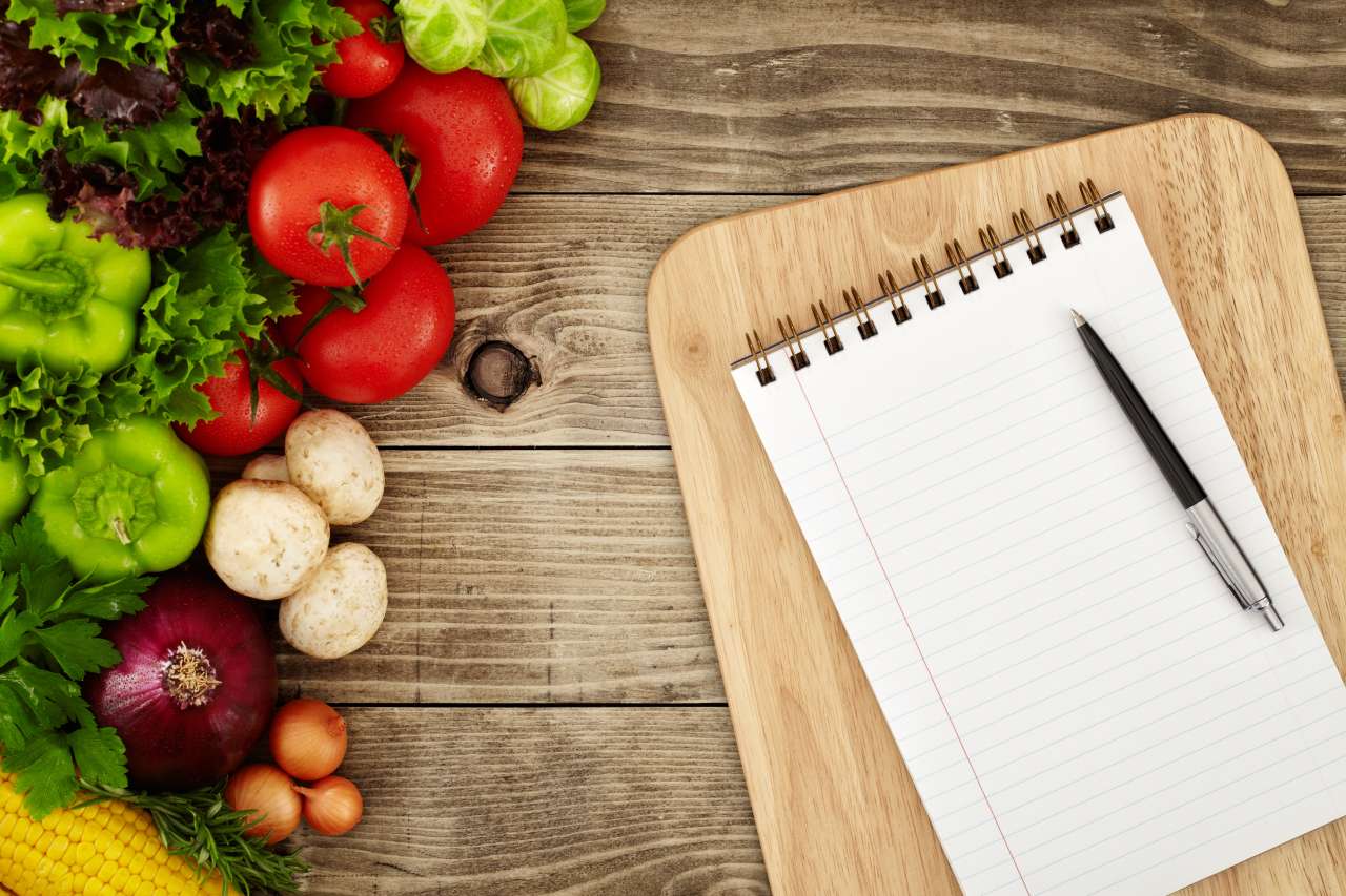 Meal plan with notepad and healthy food