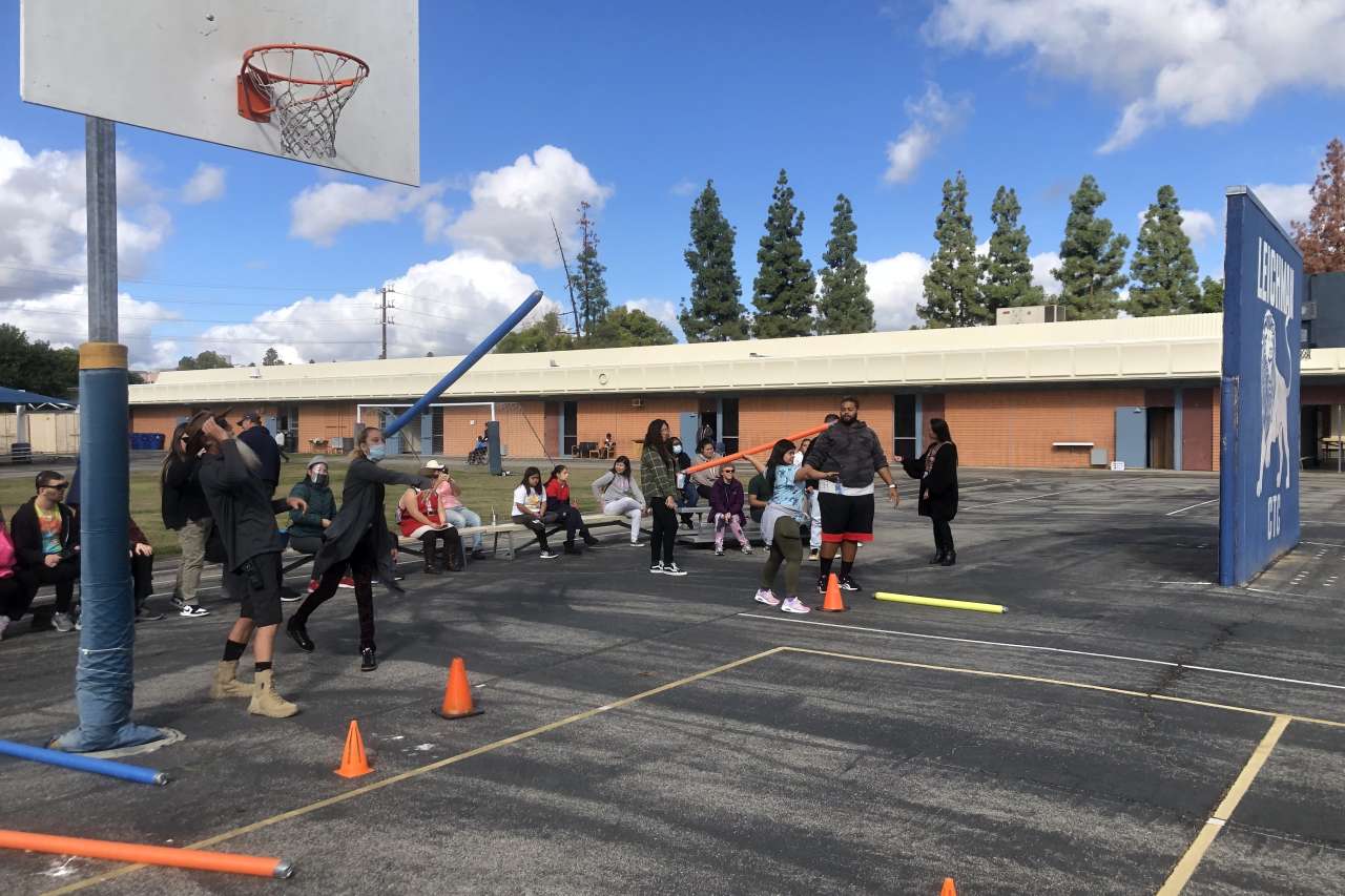 Students practice throwing adaptive javelins with Paralympian Cody Jones 