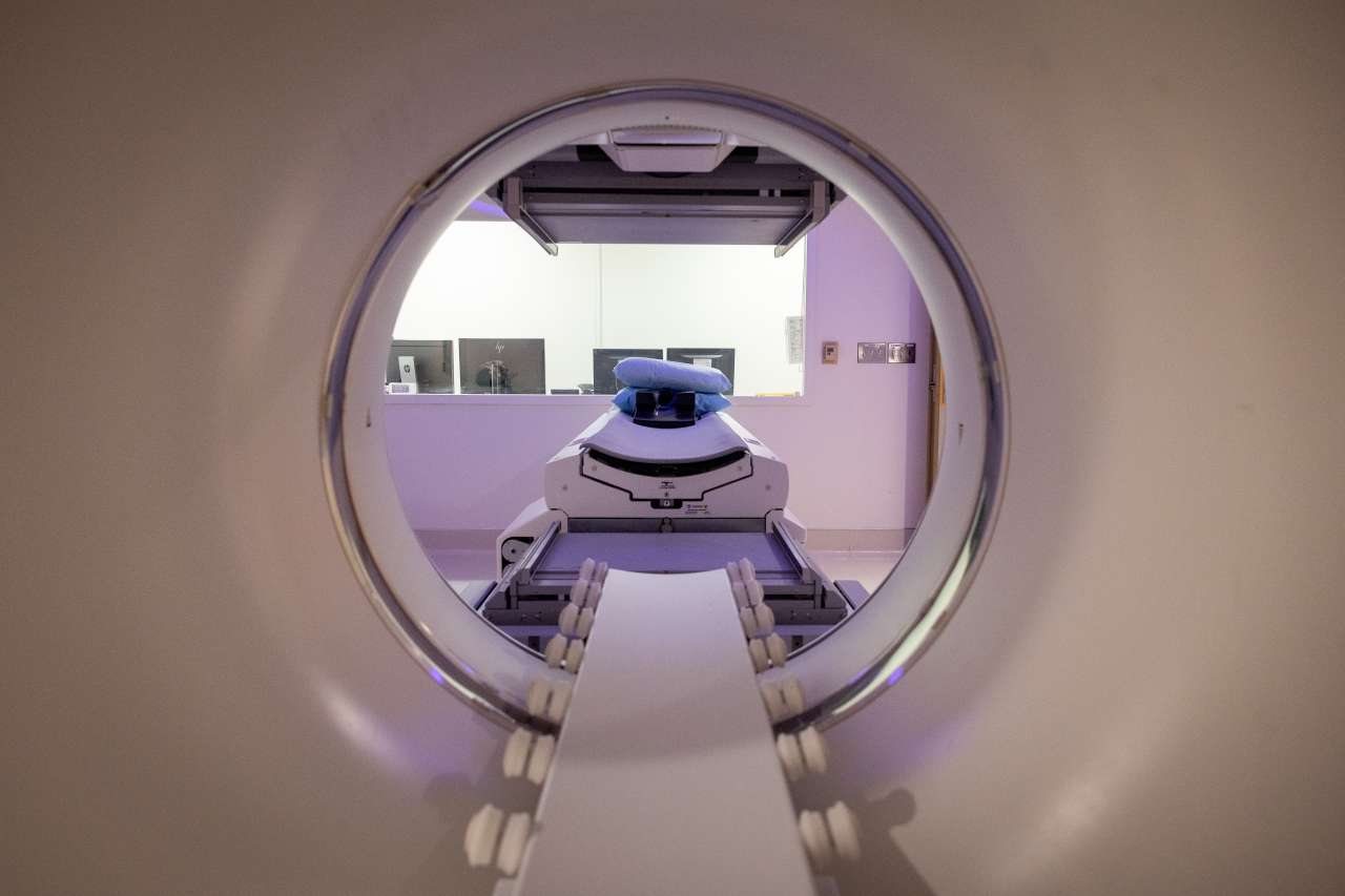 View through a medical imaging machine's opening, showing its interior and equipment.