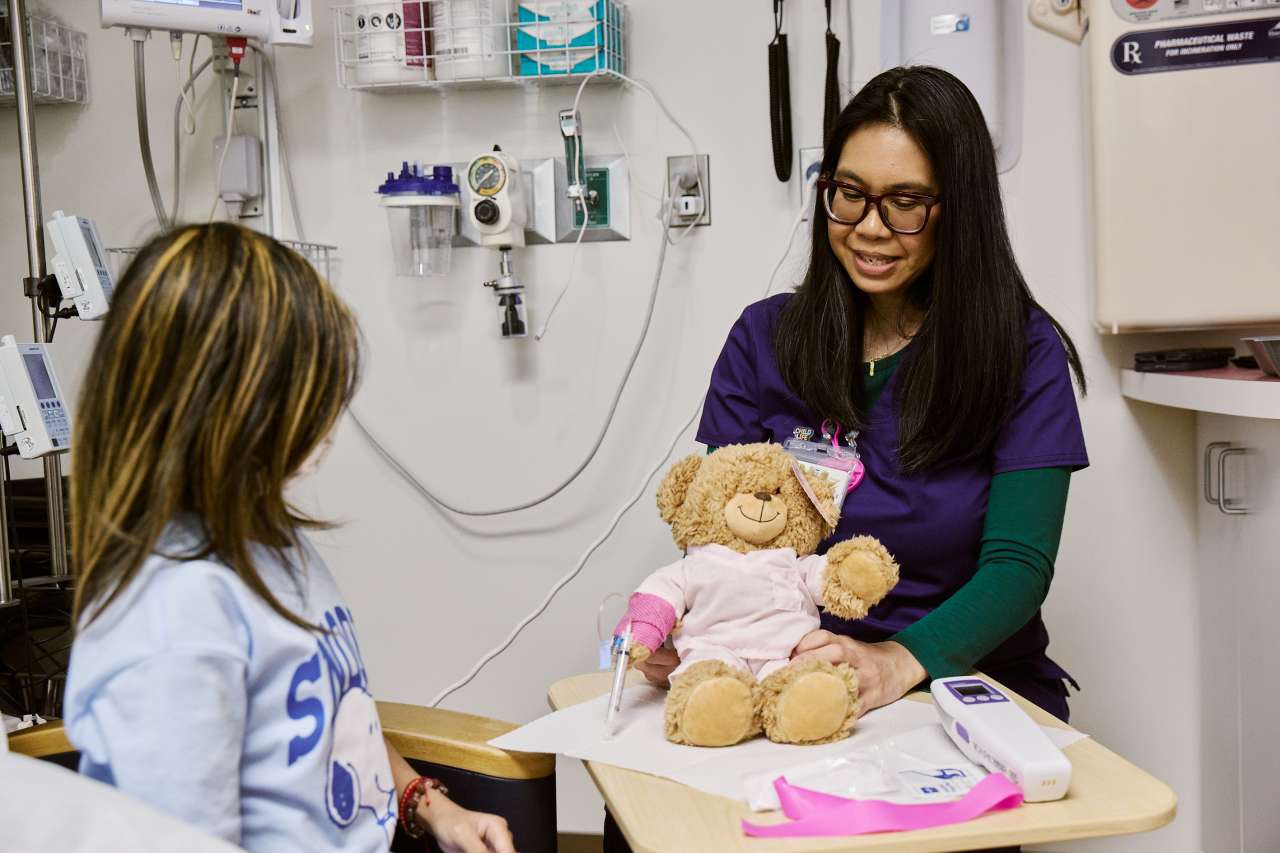 A Chase Child Life Specialist visits with a patient.