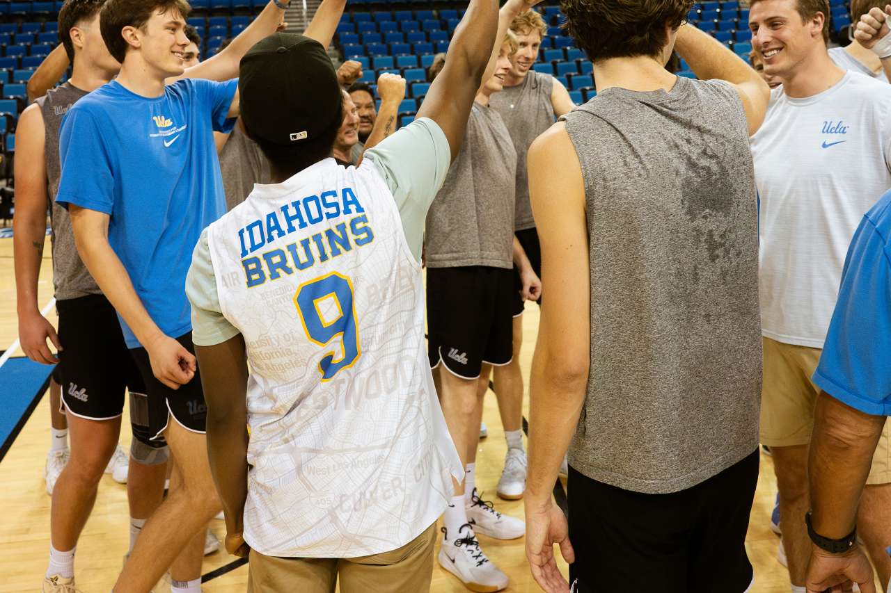 A patient celebrates on court with the UCLA men's volleyball team.