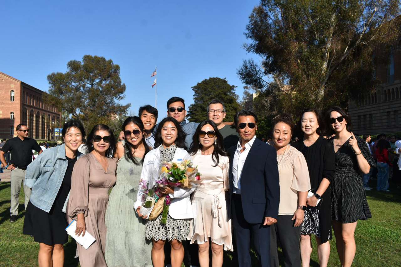 A new medical student poses with friends and family.