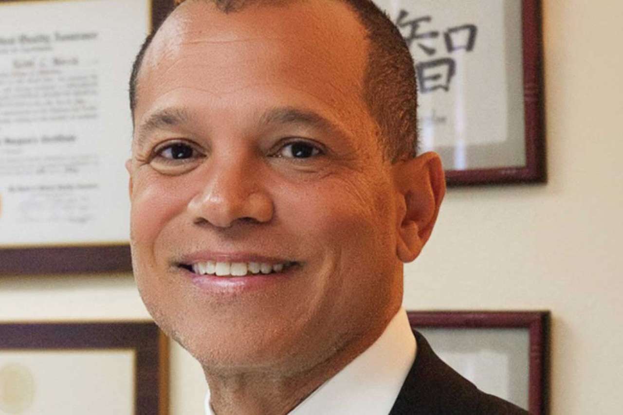 Dr. Keith C. Norris, UCLA Health physician, smiling in a professional headshot wearing a dark suit and patterned tie.